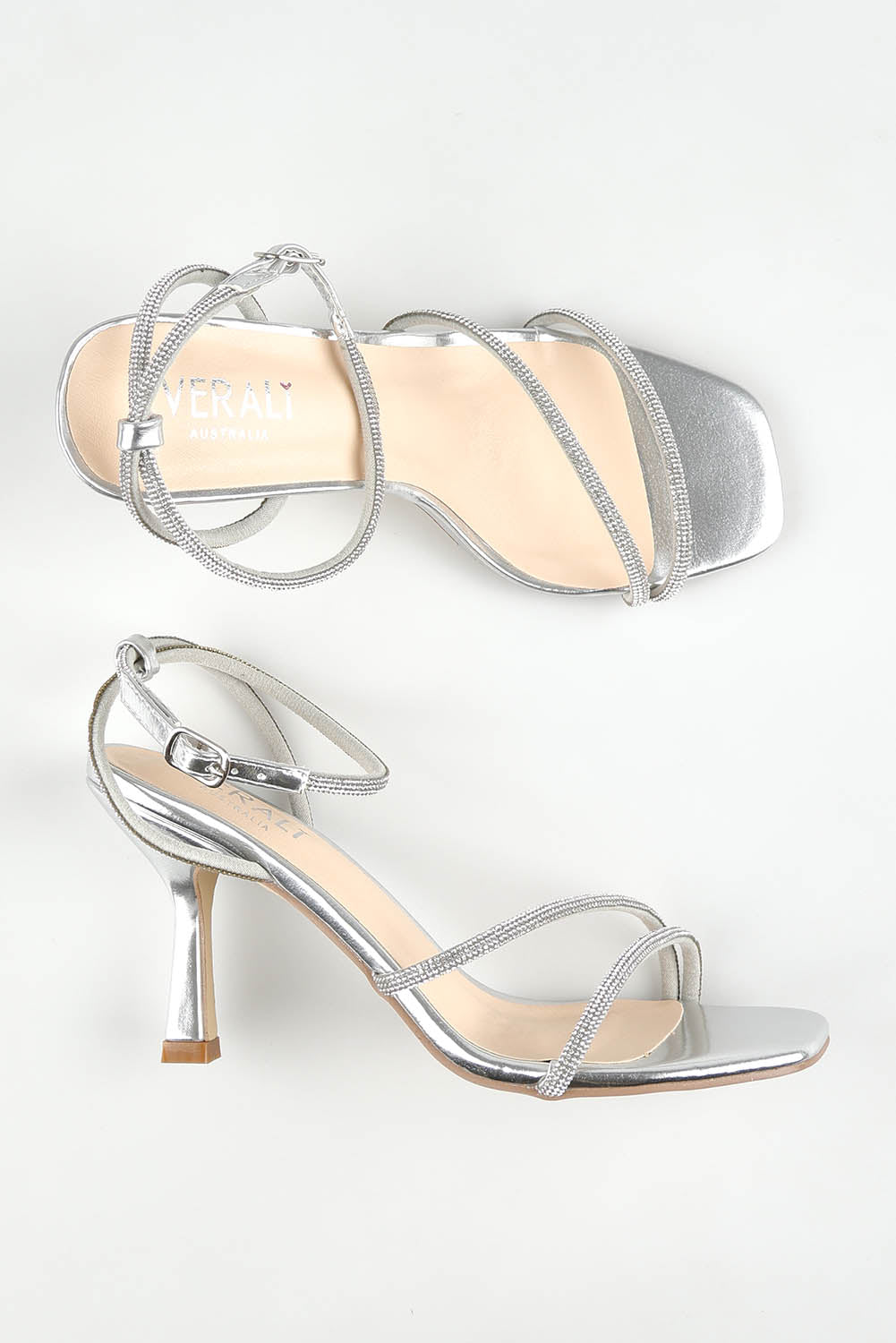 A model wearing size 37 of the Pepper Heel in colour Silver (Metallics), from the front, showing the whole outfit