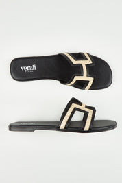 A model wearing size 37 of the Sandra Slide in colour Blackraffi (Black), from the front, showing the whole outfit