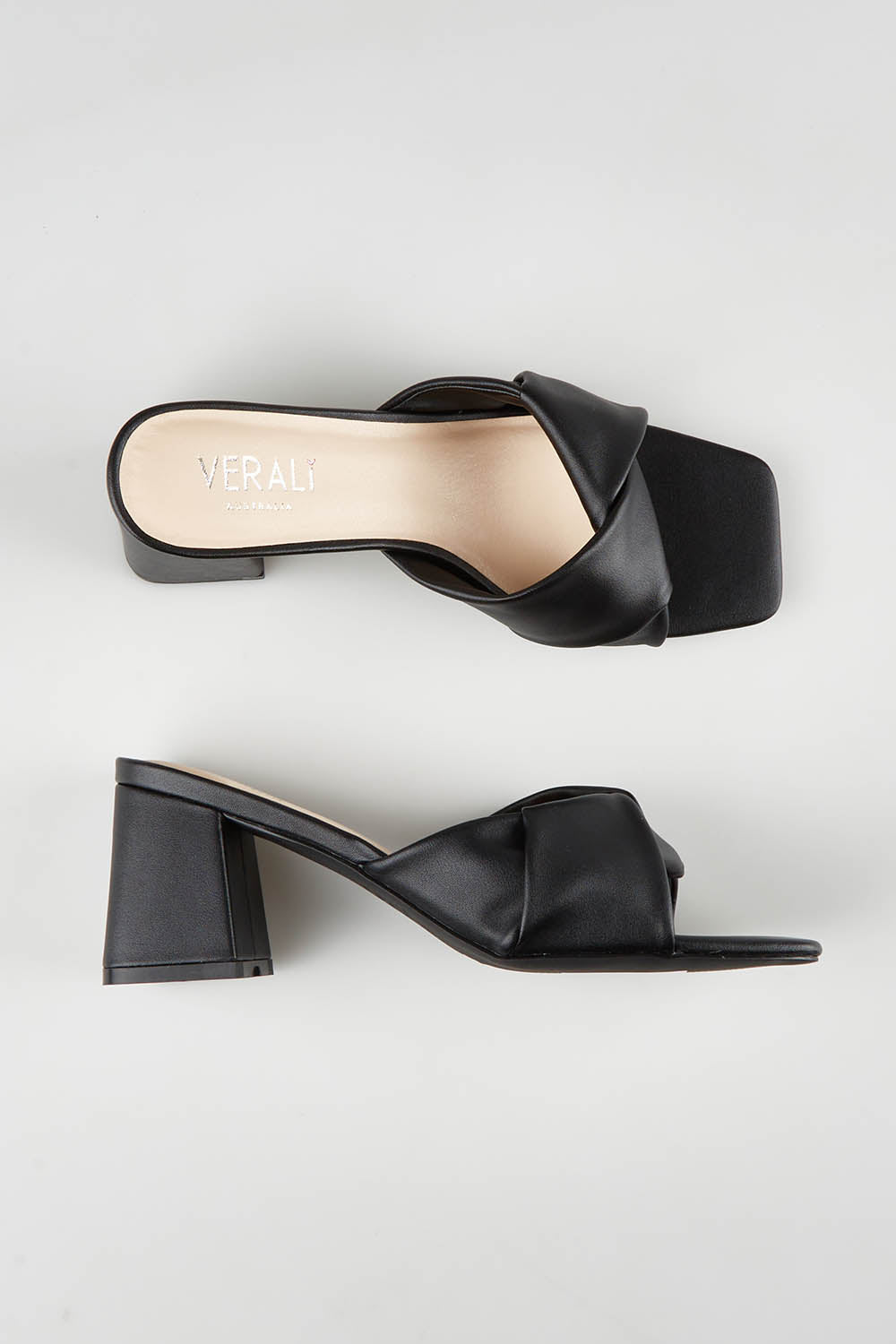A model wearing size 37 of the Stella Block Heel Mule in colour Black (Black), from the front, showing the whole outfit