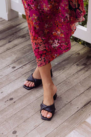 A model wearing the Stella Block Heel Mule in colour Black (Black), from the front, showing the whole outfit