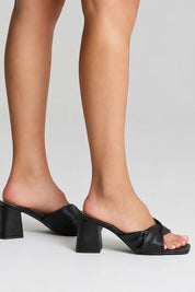 Product shot of the Stella Block Heel Mule - Black in colour Black, from the front