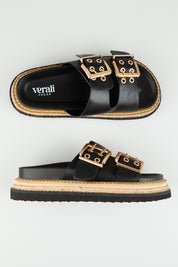 A model wearing size 37 of the Thatcher Flatform Slide in colour Black (Black), from the front, showing the whole outfit