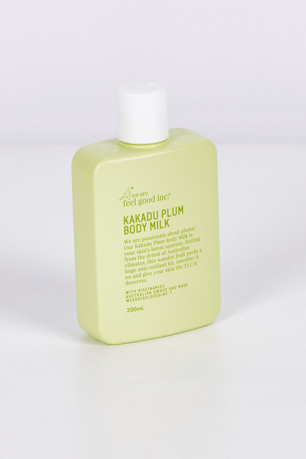 A model wearing size OneSize of the Kakadu Plum Body Milk in colour Kakadu (Green), from the front, showing the whole outfit