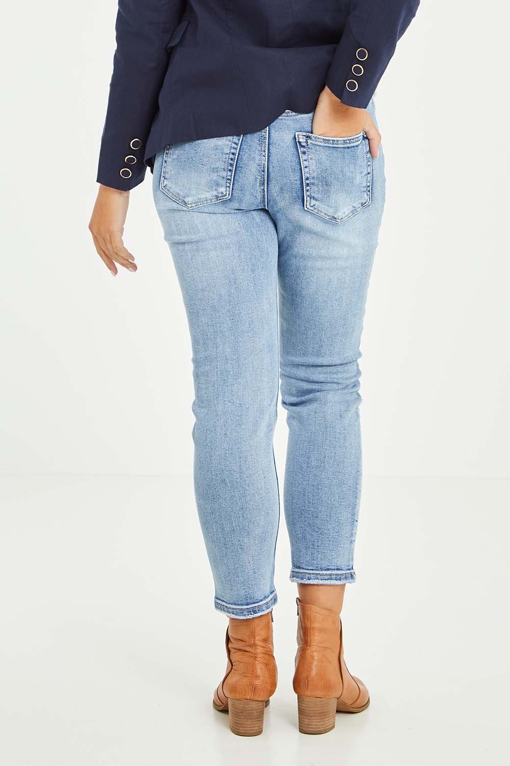 Model Tahlia wearing size 10 of the Vicky Distressed High Rise Jean in colour Blue (Blue), from the back