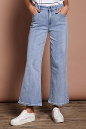 Model Madeline wearing size 9 of the Jane Highin colourWaisted Wide Leg Jean - Lightdenim (Blue), from the front, cropped image