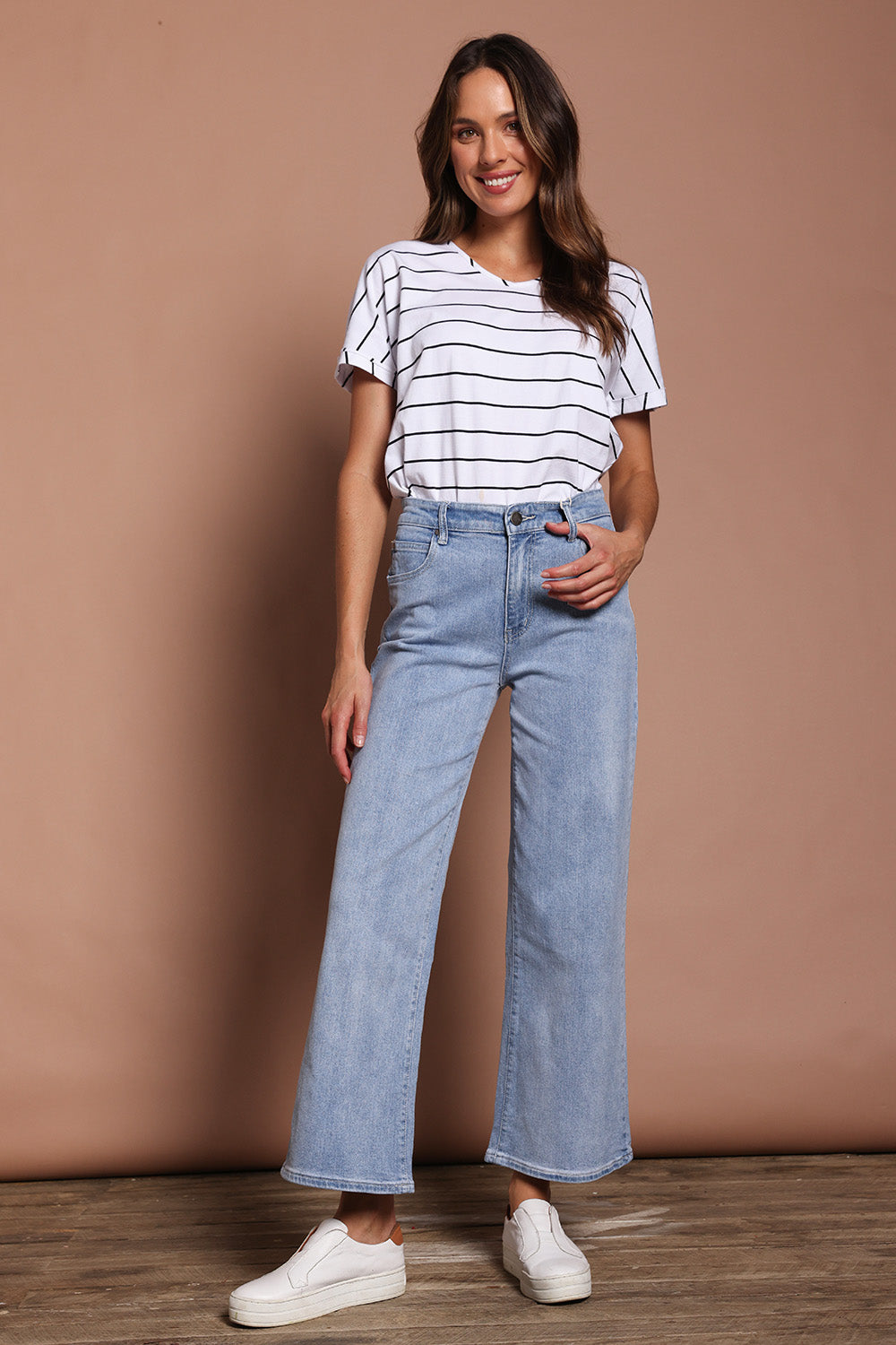Model Madeline wearing size 9 of the Jane Highin colourWaisted Wide Leg Jean - Lightdenim (Blue), from the front, showing the whole outfit