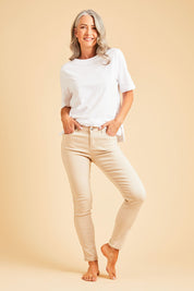 Model Luisa wearing size 10 of the Raven Skinny in colour Cream (White), from the front, showing the whole outfit
