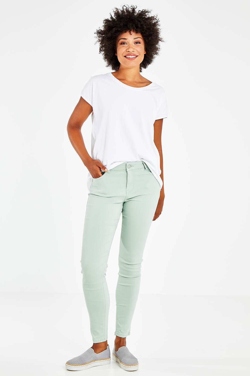 Model Olivia wearing size 10 of the Raven Skinny in colour Green (Green), from the front, showing the whole outfit