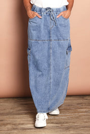 Model Sandy wearing size 10 of the Millie Pull On Denim Skirt in colour Denim (Blue), from the front, cropped image