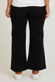 Model Laura wearing size 14 of the Candice Wide Leg Jean in colour Black (Blue), from the back