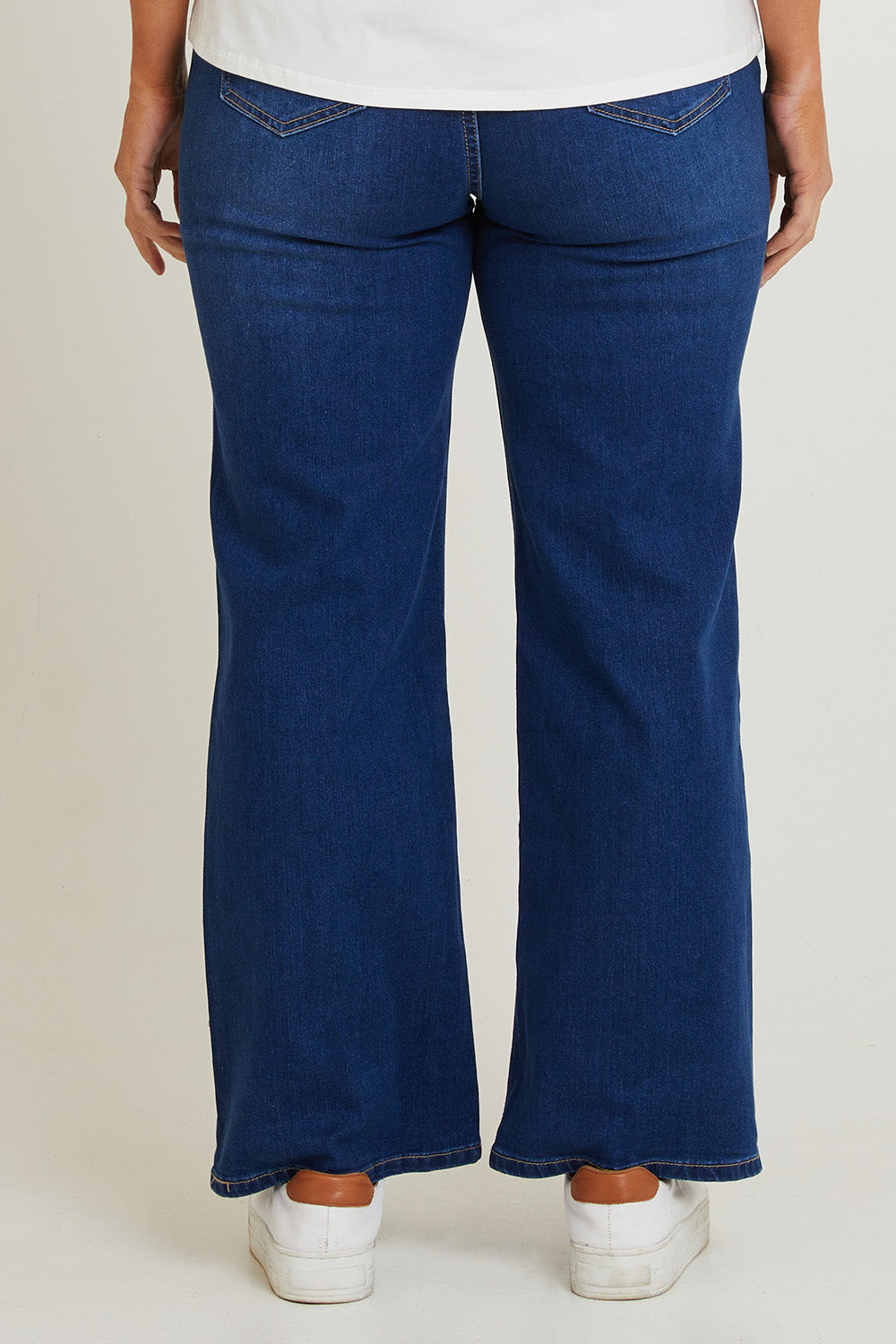 Model Laura wearing size 14 of the Candice Wide Leg Jean in colour Darkblue (Blue), from the back