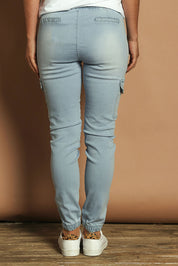 Model Katie wearing size 10 of the Harlow Cargo Jogger in colour Lightdenim (Blue), from the back