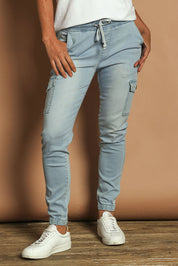Model Katie wearing size 10 of the Harlow Cargo Jogger in colour Lightdenim (Blue), from the front, cropped image