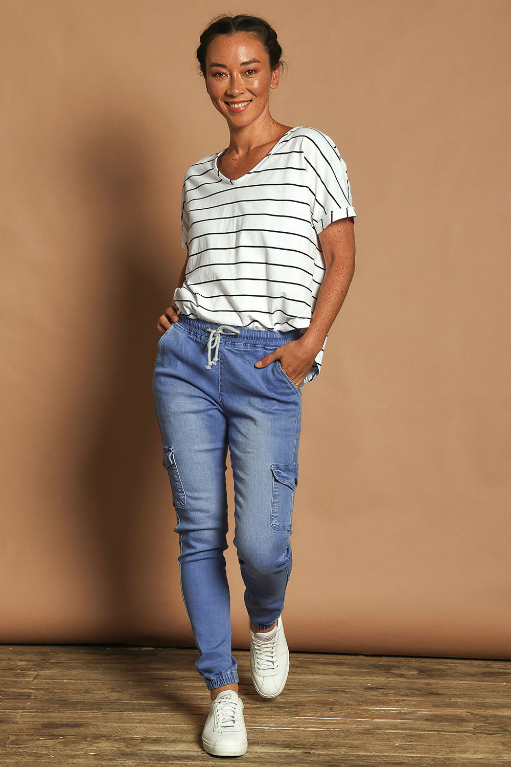 Model Katie wearing size 10 of the Harlow Cargo Jogger in colour Middenim (Blue), from the front, showing the whole outfit