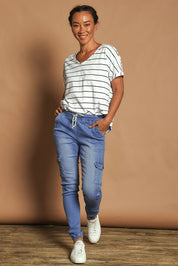 Model Katie wearing size 10 of the Harlow Cargo Jogger in colour Middenim (Blue), from the front, showing the whole outfit