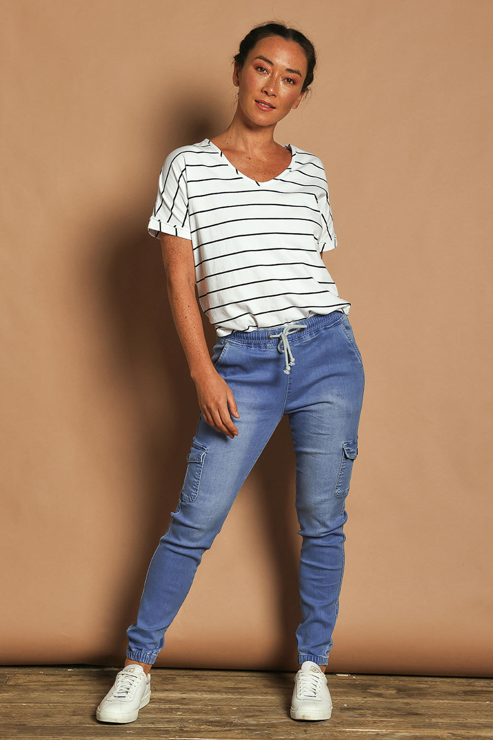 Model Katie wearing size 10 of the Harlow Cargo Jogger in colour Middenim (Blue), from the front, showing the whole outfit