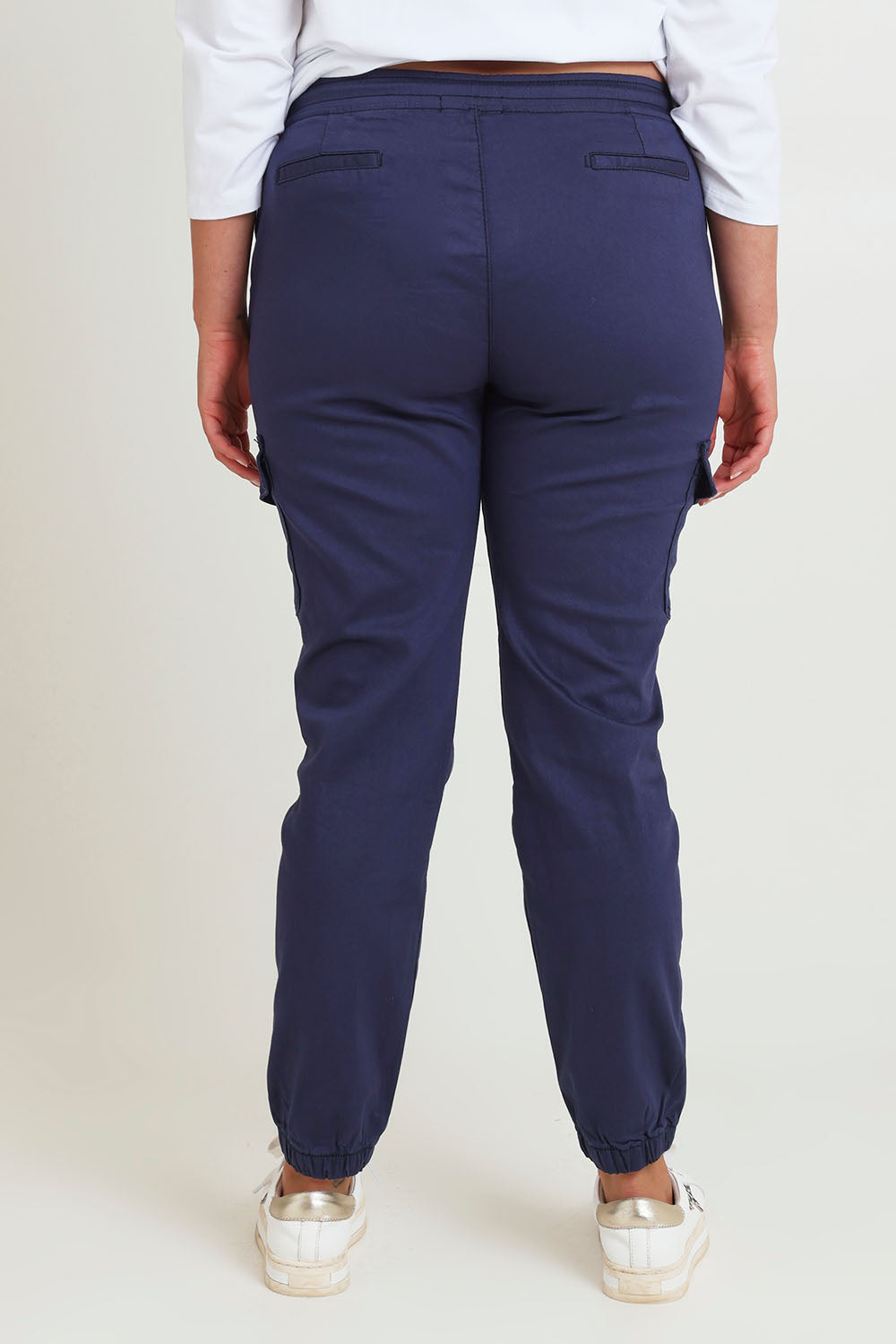 Model Chanel wearing size 16 of the Harlow Cargo Jogger in colour Navy (Blue), from the back