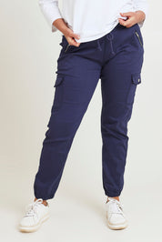 Model Chanel wearing size 16 of the Harlow Cargo Jogger in colour Navy (Blue), from the front, cropped image