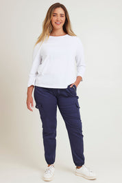 Model Chanel wearing size 16 of the Harlow Cargo Jogger in colour Navy (Blue), from the front, showing the whole outfit