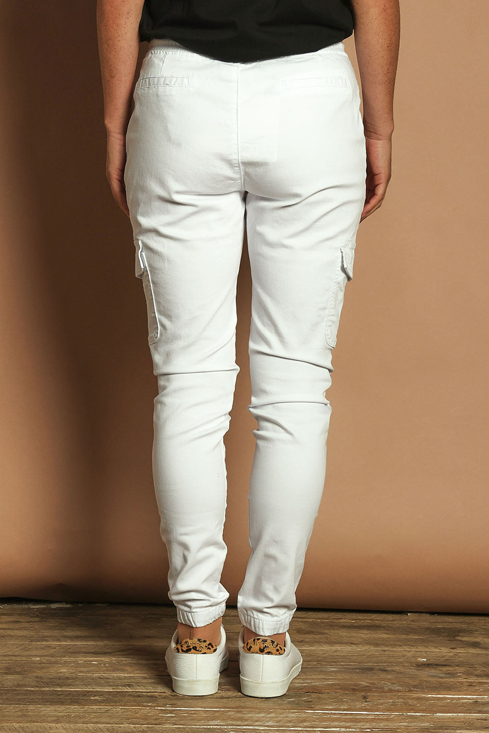 Model Katie wearing size 10 of the Harlow Cargo Jogger in colour White (White), from the back