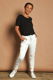 Model Katie wearing size 10 of the Harlow Cargo Jogger in colour White (White), from the front, showing the whole outfit