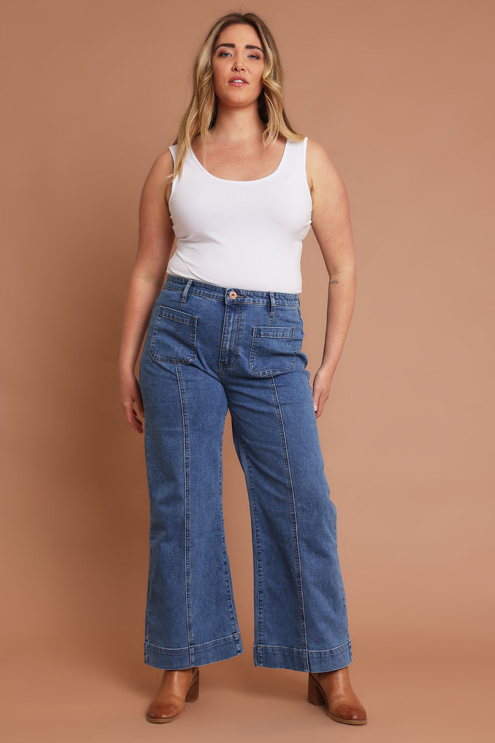 Model Chanel wearing size 16 of the Charlotte High Waisted Front Pocket Wide Leg Jean in colour Middenim (Blue), from the front, showing the whole outfit
