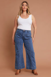 Model Chanel wearing size 16 of the Charlotte High Waisted Front Pocket Wide Leg Jean in colour Middenim (Blue), from the front, showing the whole outfit