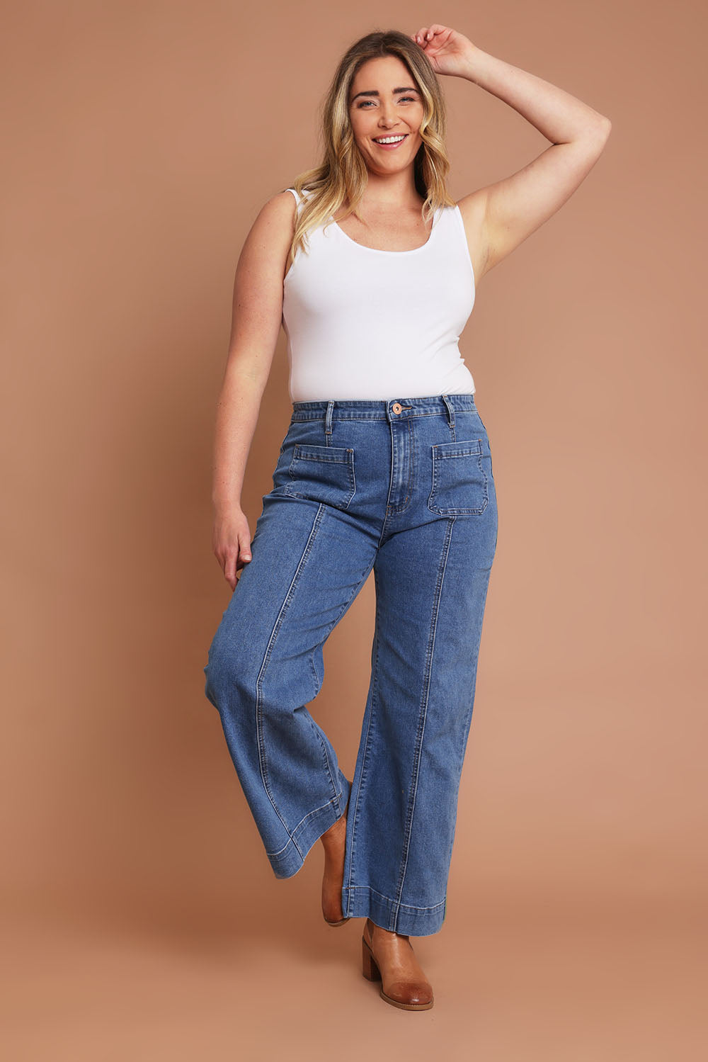 Model Chanel wearing size 16 of the Charlotte High Waisted Front Pocket Wide Leg Jean in colour Middenim (Blue), from the front, showing the whole outfit