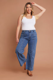 Model Chanel wearing size 16 of the Charlotte High Waisted Front Pocket Wide Leg Jean in colour Middenim (Blue), from the front, showing the whole outfit