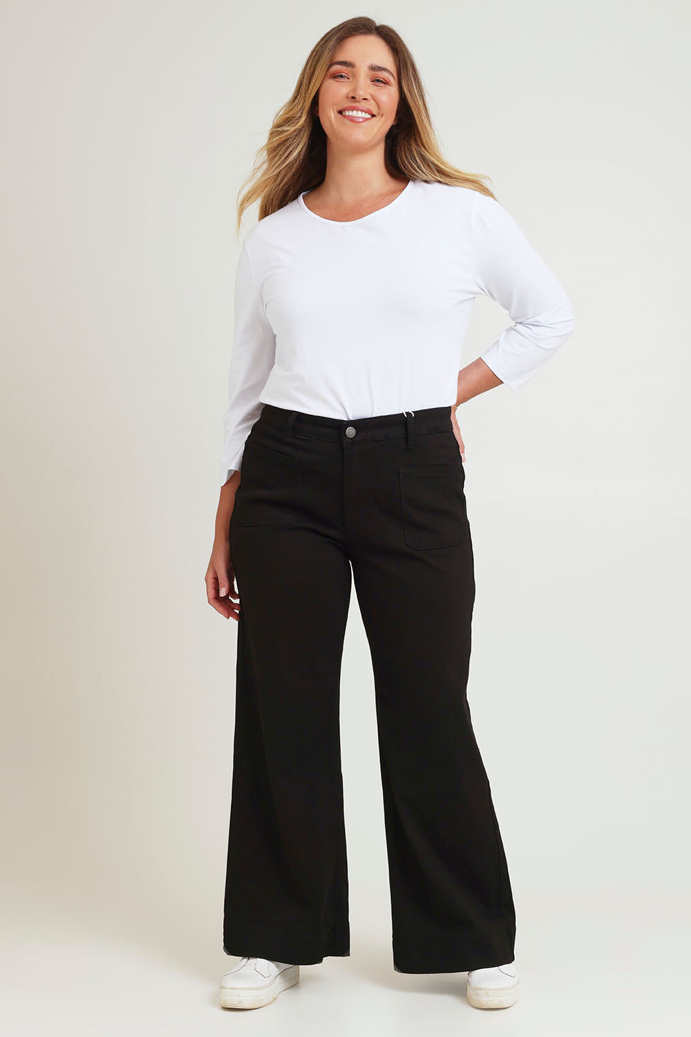 Model Chanel wearing size 16 of the Katie Highin colourWaisted Front Pocket Wide Leg Jean - Black (Black), from the front, showing the whole outfit