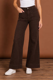 Model Genericm wearing size sample of the Katie High-waisted Front Pocket Wide Leg Jean - Chocolate in colour Chocolate, in a cropped view