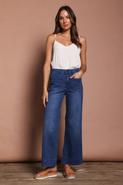 Model Madeline wearing size 9 of the Katie Highin colourWaisted Front Pocket Wide Leg Jean - Darkdenim (Blue), from the front, showing the whole outfit