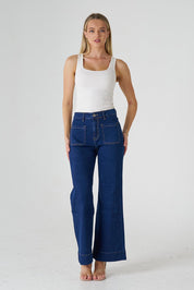 A model wearing the Katie Highin colourWaisted Front Pocket Wide Leg Jean - Indigoden (Blue), from the front, showing the whole outfit