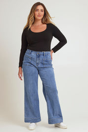 Model Chanel wearing size 16 of the Katie Highin colourWaisted Front Pocket Wide Leg Jean - Lightdenim (Blue), from the front, showing the whole outfit