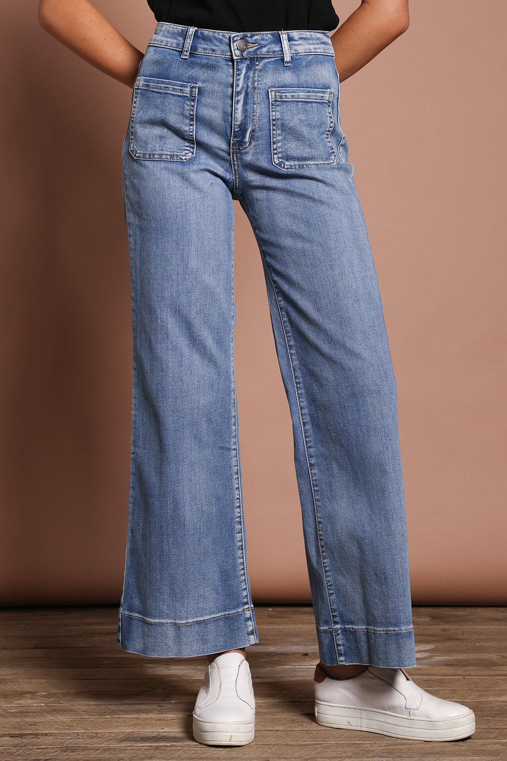 Model Madeline wearing size 9 of the Katie Highin colourWaisted Front Pocket Wide Leg Jean - Lightdenim (Blue), from the front, cropped image