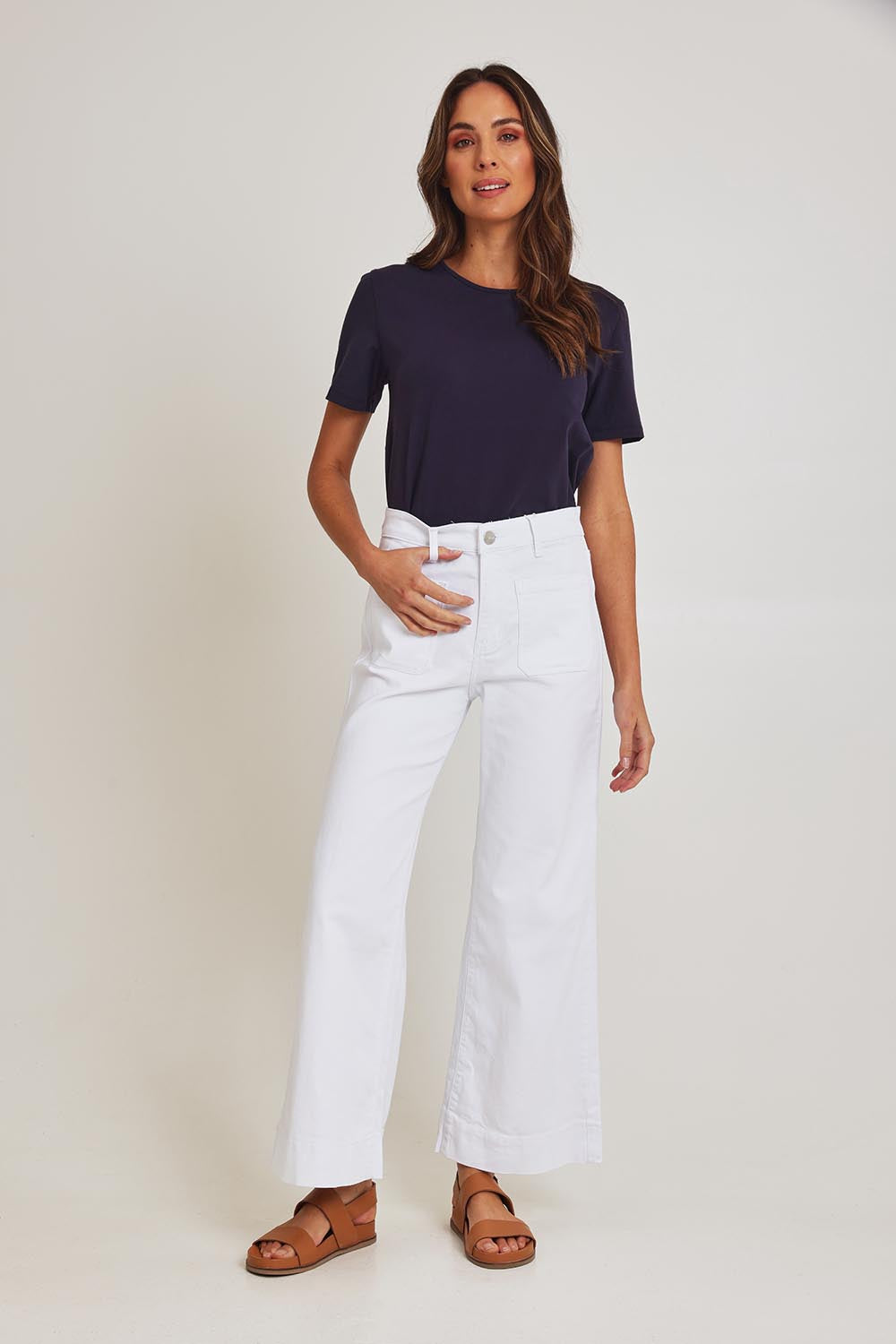 Model Madeline wearing size 10 of the Katie Highin colourWaisted Front Pocket Wide Leg Jean - White (White), from the front, showing the whole outfit