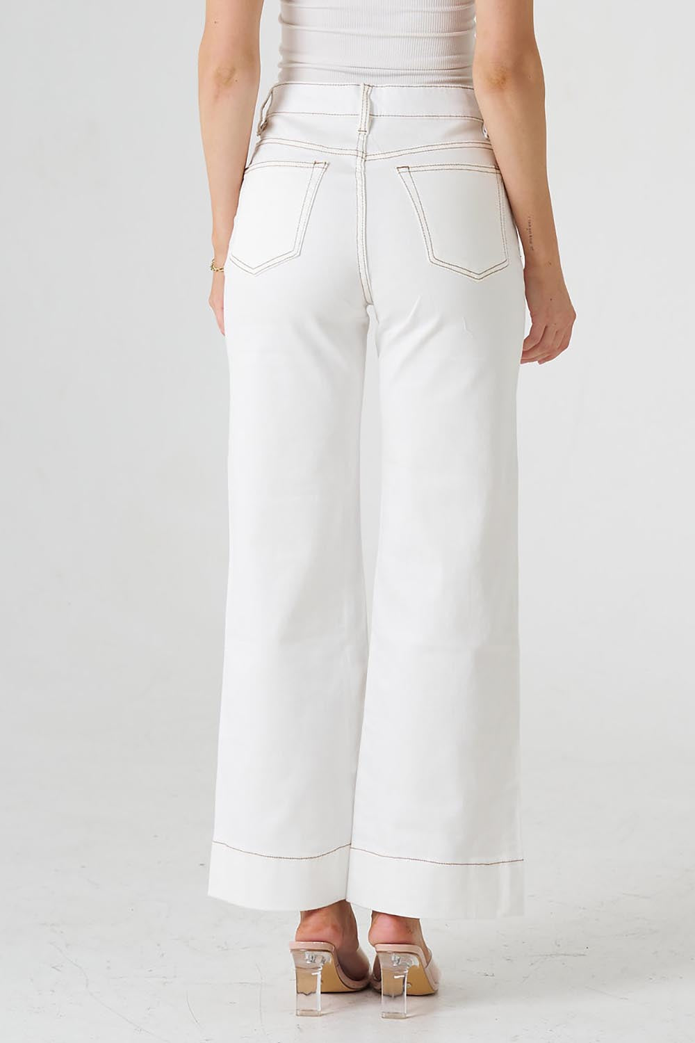 A model wearing the Katie Highin colourWaisted Front Pocket Wide Leg Jean - Whitstitch (White), from the back