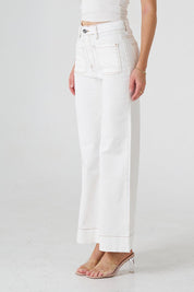 A model wearing the Katie Highin colourWaisted Front Pocket Wide Leg Jean - Whitstitch (White), from the front, cropped image