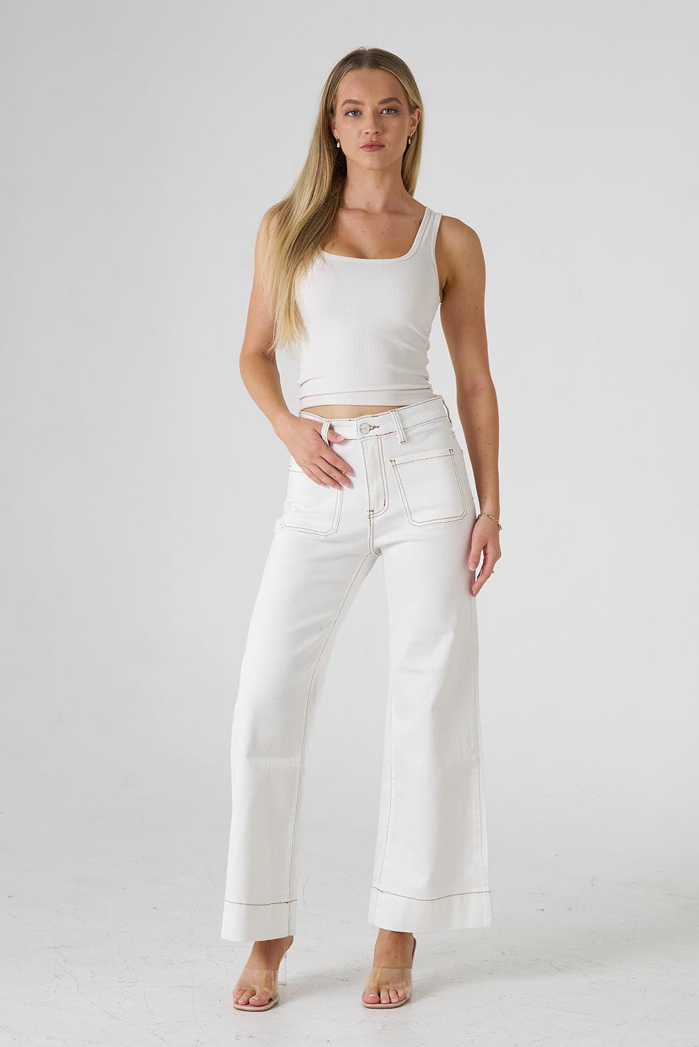 A model wearing the Katie Highin colourWaisted Front Pocket Wide Leg Jean - Whitstitch (White), from the front, showing the whole outfit