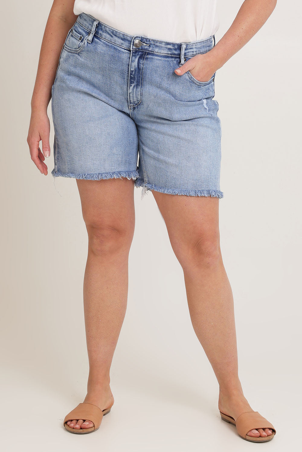 Model Chanel wearing size 16 of the Kerrie Frayed Hem Shorts in colour Lightdenim (Blue), from the front, cropped image