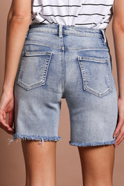 Model Madeline wearing size 10 of the Kerrie Frayed Hem Shorts in colour Lightdenim (Blue), from the back
