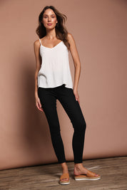 Model Madeline wearing size 10 of the Paige Pull On Jean in colour Black (Black), from the front, showing the whole outfit