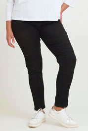 Model Chanel wearing size 16 of the River Ribbed Pull On Jean in colour Black (Black), from the front, cropped image