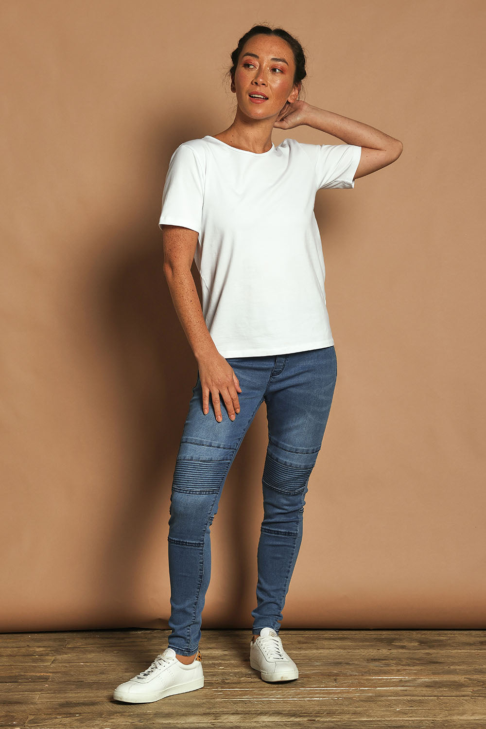 Model Katie wearing size 10 of the River Ribbed Pull On Jean in colour Midblue (Blue), from the front, showing the whole outfit