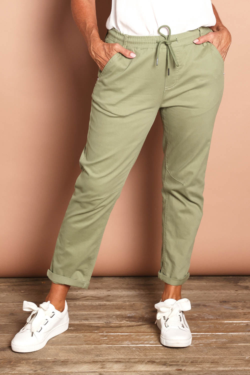 Model Sandy wearing size 10 of the Robin Drawstring Pull On Pant in colour Khaki (Green), from the front, cropped image
