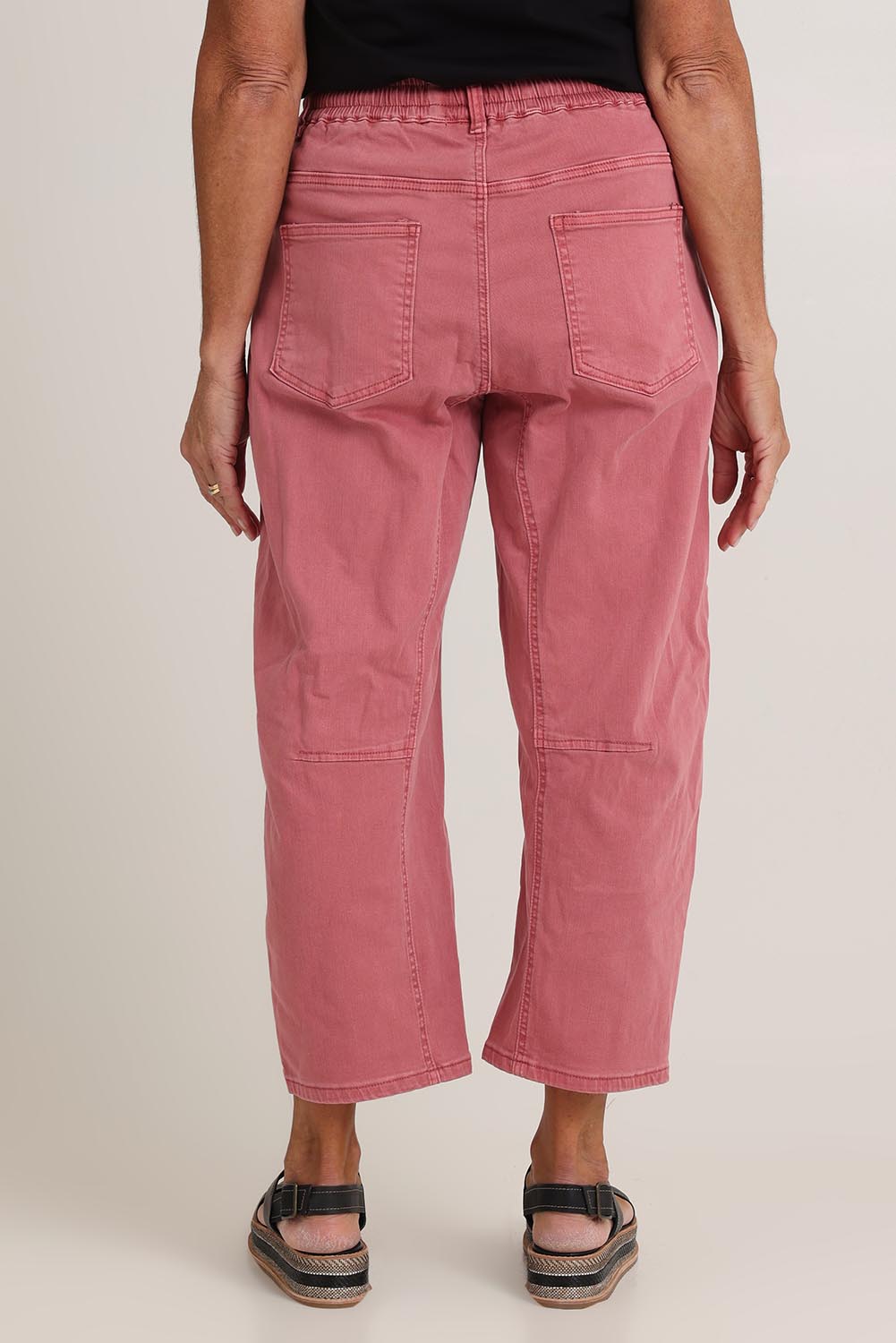 Model Sandy wearing size 10 of the Rubi Pocket Barrel Jean in colour Red (Red), from the back