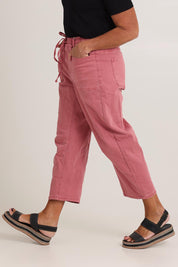 Model Sandy wearing size 10 of the Rubi Pocket Barrel Jean in colour Red (Red), from the front, cropped image