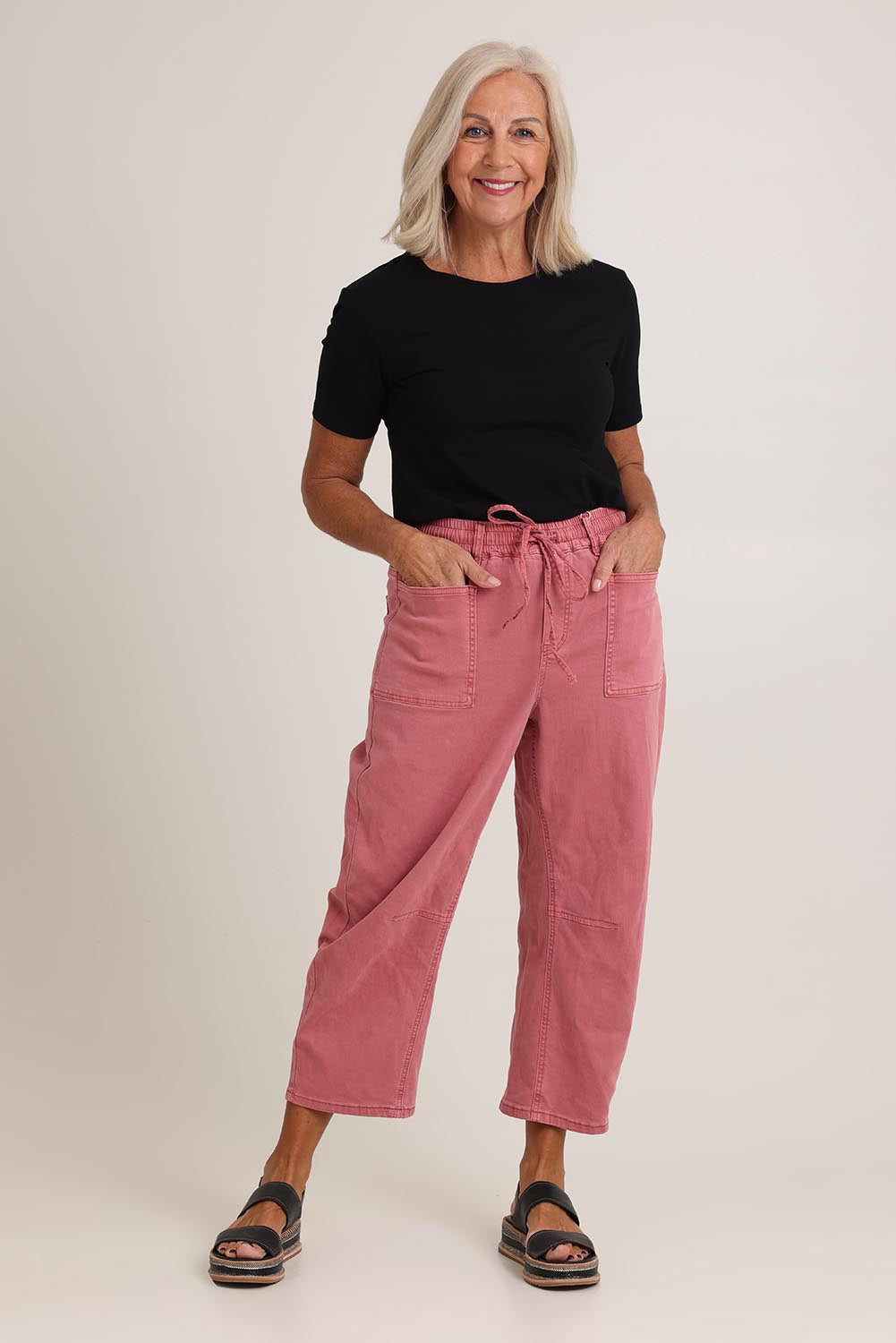 Model Sandy wearing size 10 of the Rubi Pocket Barrel Jean in colour Red (Red), from the front, showing the whole outfit