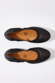 A model wearing size 37 of the Ava Leather Flat in colour Black (Black), from the front, showing the whole outfit