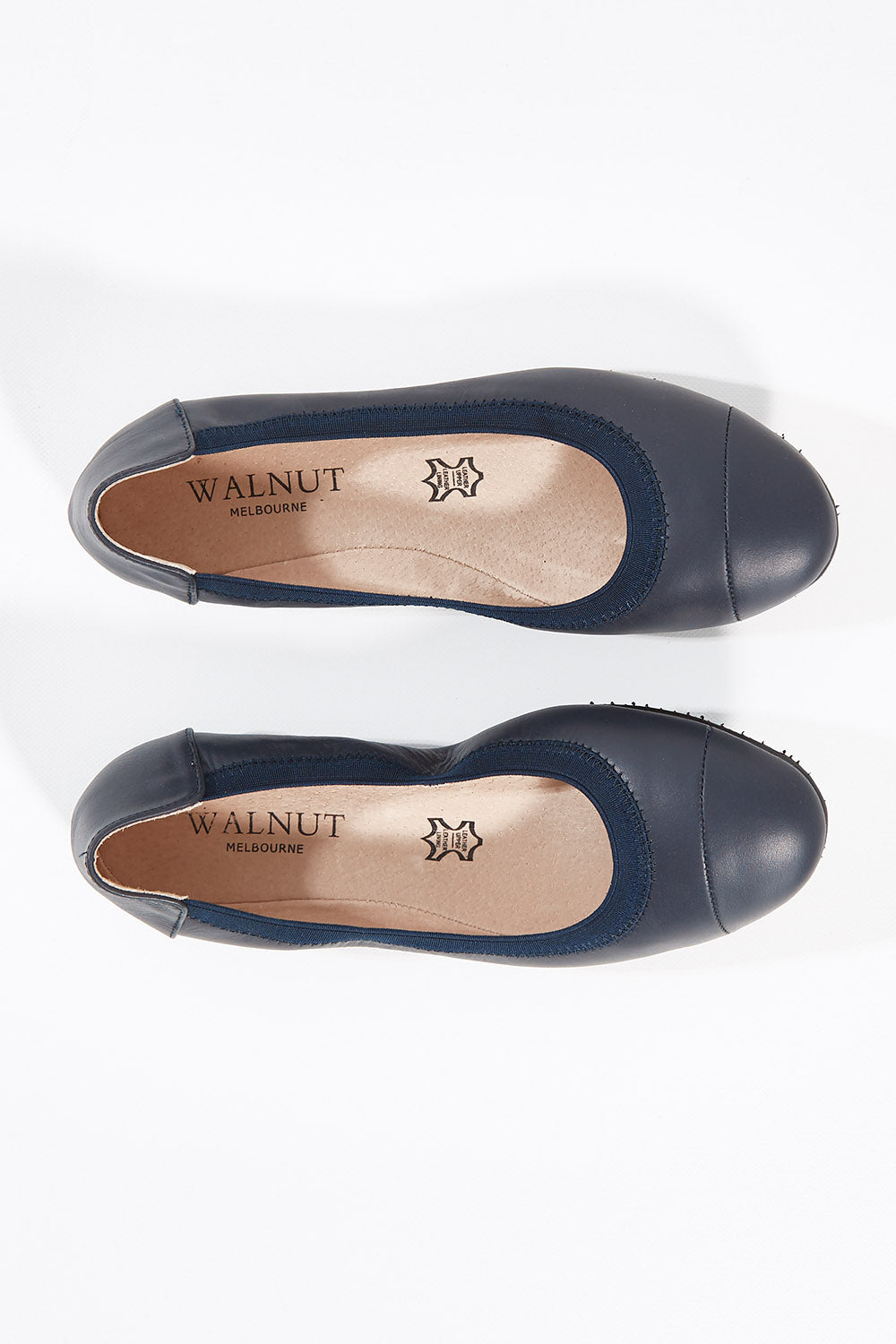 A model wearing size 37 of the Ava Leather Flat in colour Navy (Blue), from the front, showing the whole outfit